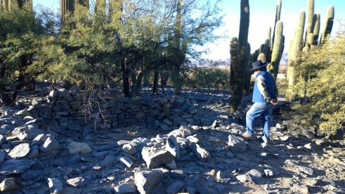 Man walks around the site of Cerro Quemado.